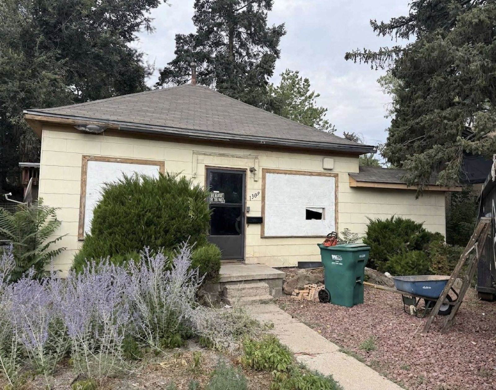 Colorado property with boarded windows and visible exterior wear